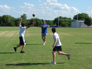 Asst. Coach Ric Meshew goes through some drills with campers at the GHS practice field. Photo By Chris Evans