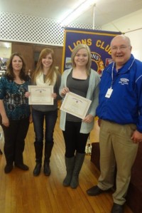 Lion Janna Pierson (L) and Lion Mike Simpson (R)  recognize Guthrie High School students Zoe Hamby (LC) and Jamie Hurren (RC) for their academic achievement and student leadership.
