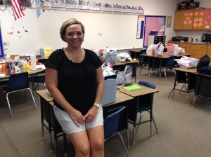 Julie Wiss, second grade teacher at Mulhall-Orlando Schools, sits in her classroom amidst school supplies donated and delivered by the Logan County United Way Board.