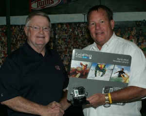 TCSM board member John Vance at right displays a GoPro HERO3 silver edition professional video camera he is contributing Wednesday to the museum as he shakes hands with TCSM executive director Richard Hendricks. Photo by Darl DeVault