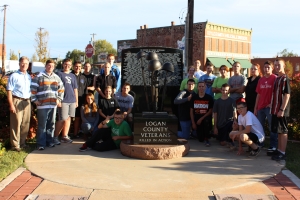 Major Mick Fredrickson, (L), faculty instructor, leads Junior ROTC students from Guthrie High School on a mission of “clean up, fix up and paint up” the Veterans Memorial at Honor Park in Guthrie.