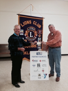 Guthrie Lions Club Vice President, Richard Ireton  (R) presents a check for $2,000 to Steve Gentling (L), President of United Way of Logan County.