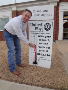  Ed Stanton, Crescent City Manager, updates the United Way of Logan County Thermometer and celebrates Crescent city employees being recognized as members of the “100% Club”