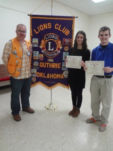 Lion President, John Wood (L) presents recognitions of “Student of the Month” to Kaylea Hopfer (C) and Tyler Porter (R) for their outstanding achievements